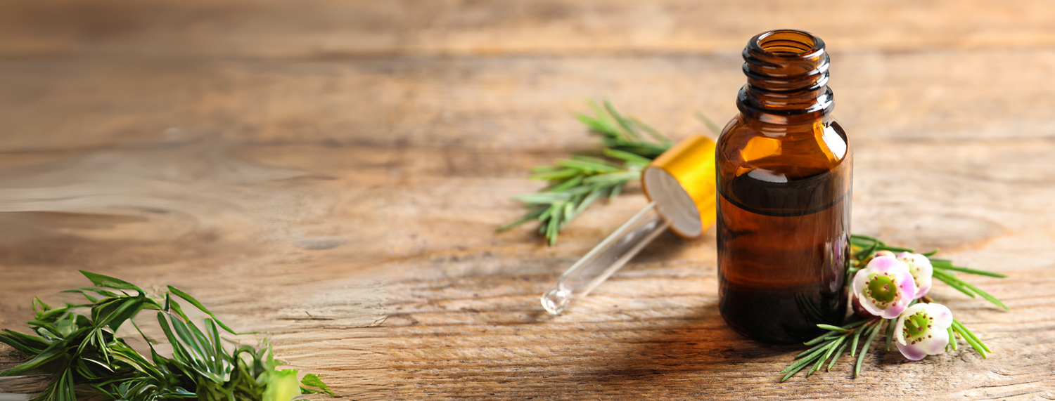 amber bottle on a table top filled with oil set with flowers