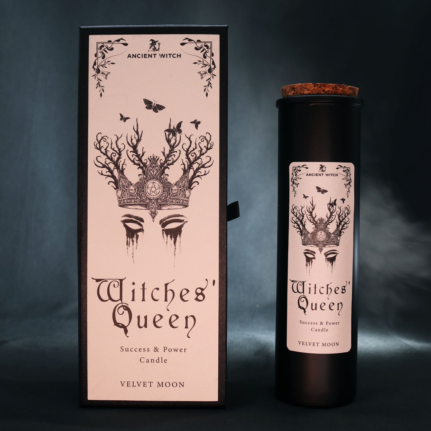 Witches' Queen candle packaging with decorative design and text on a dark smoke background