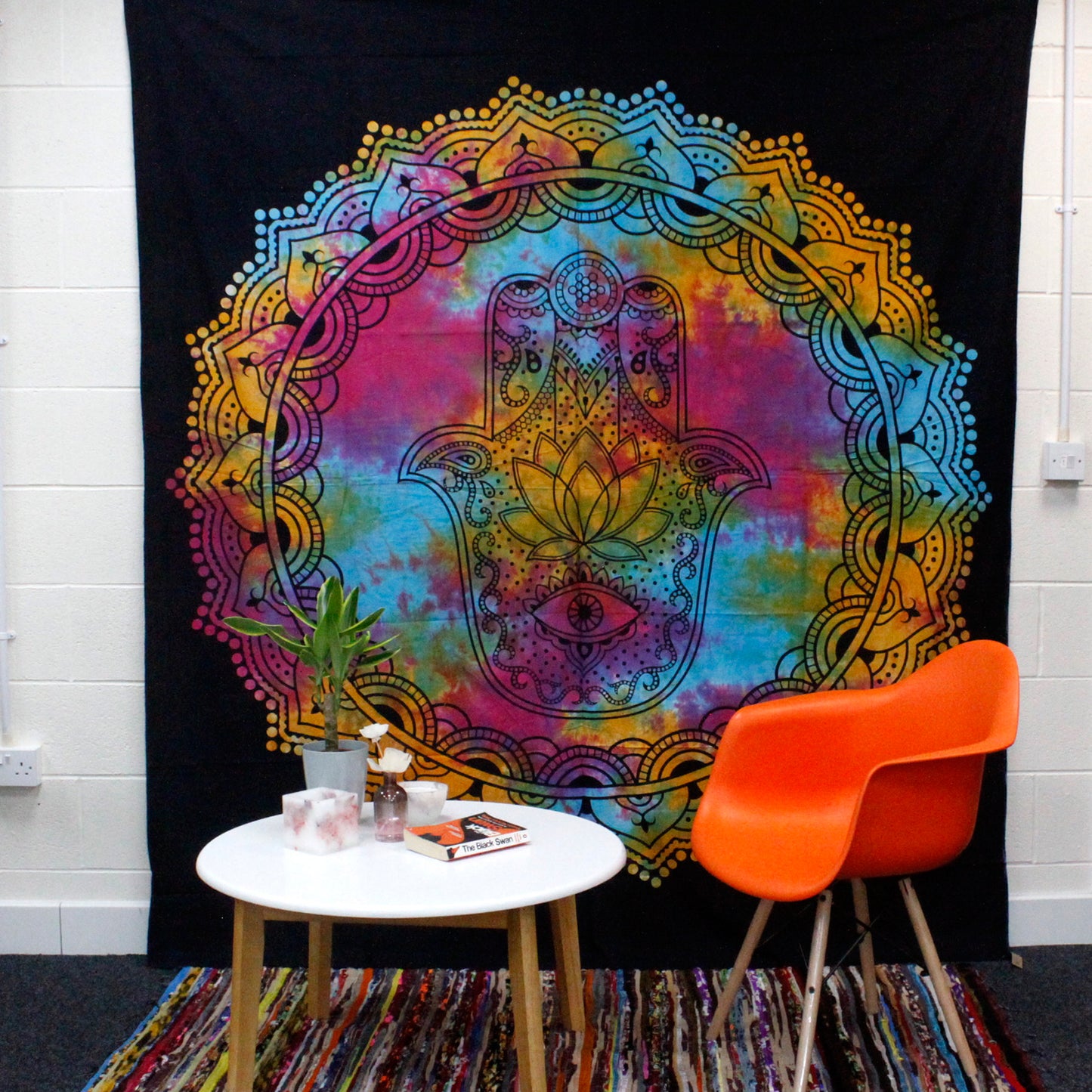 Double Cotton Bedspread + Wall Hanging - Black Hamsa hanging on the wall with a white table and a orange chair