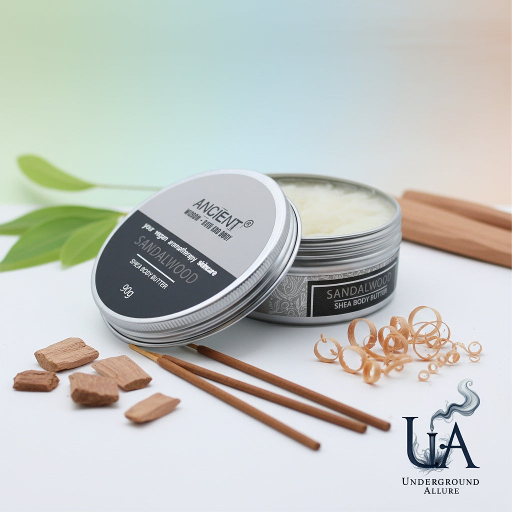 Shea body butter with sandalwood fragrance on a white surface with Sandalwood sticks and leaves.