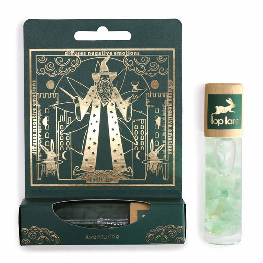 The image shows a Green package - Hop Hare Essential Oil Gemstone Roll On - The Magician essential oil roll-on bottle with a gemstone section, and a detachable tarot card displayed next to it.Underground Allure Essex, UK