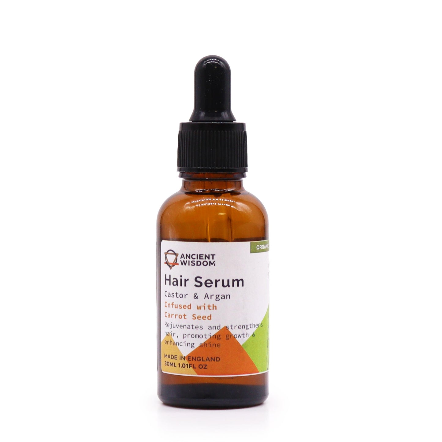 A bottle of Ancient Wisdom Organic Hair Serum with a label indicating 'Castor & Argan Oils' and 'Carrot Seed'. The bottle is amber-colored and has a dropper.