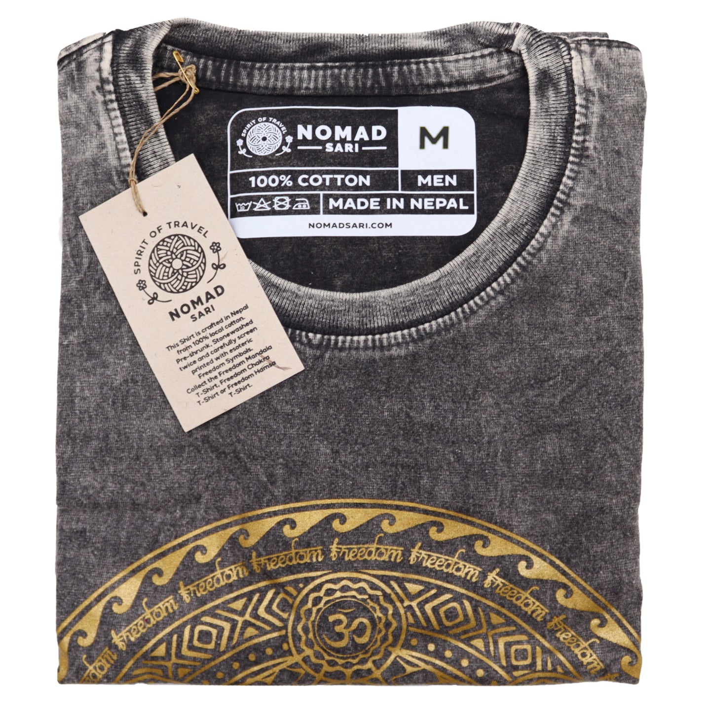 Folded gray t-shirt with gold design and Nomad Sari label on a white background
