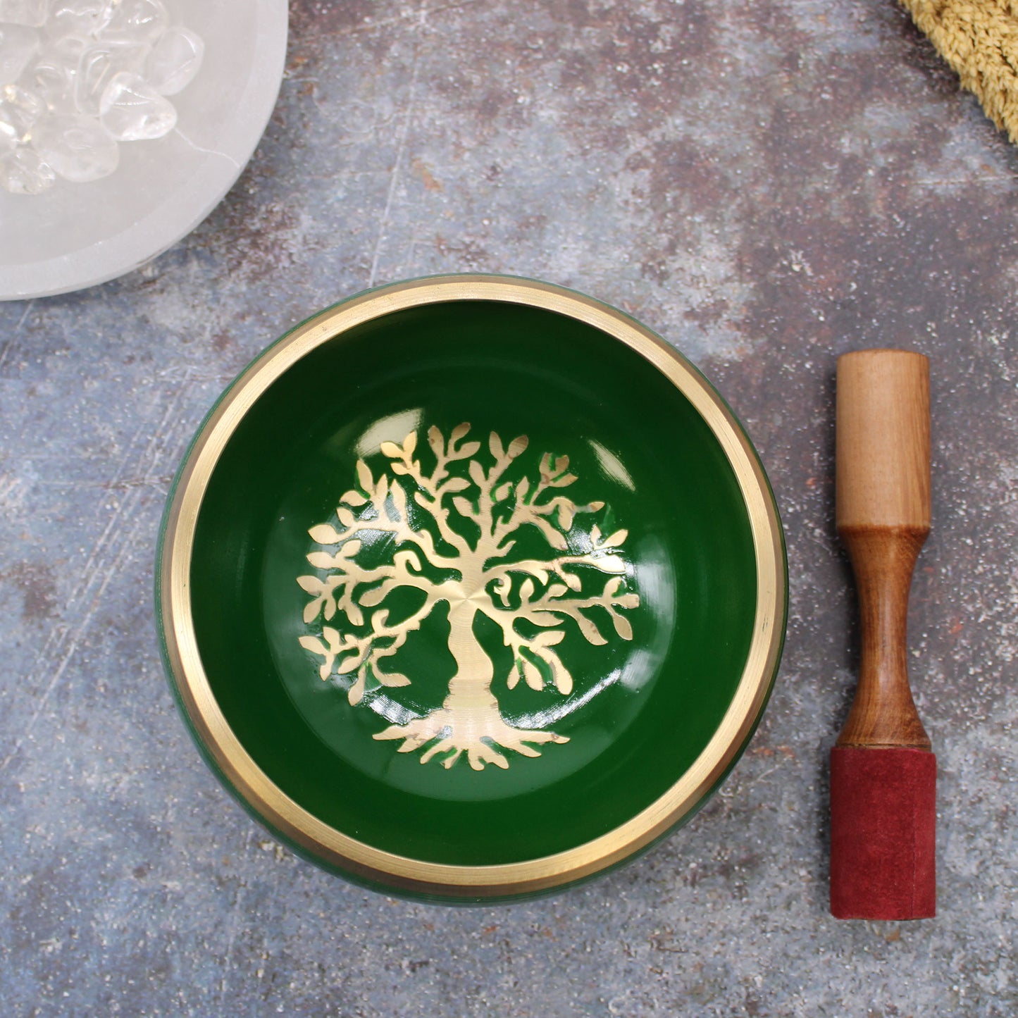 A singing bowl set including a blue and white singing bowl with a gold rim, a wooden mallet, and a black carrying bag, displayed on a white background.