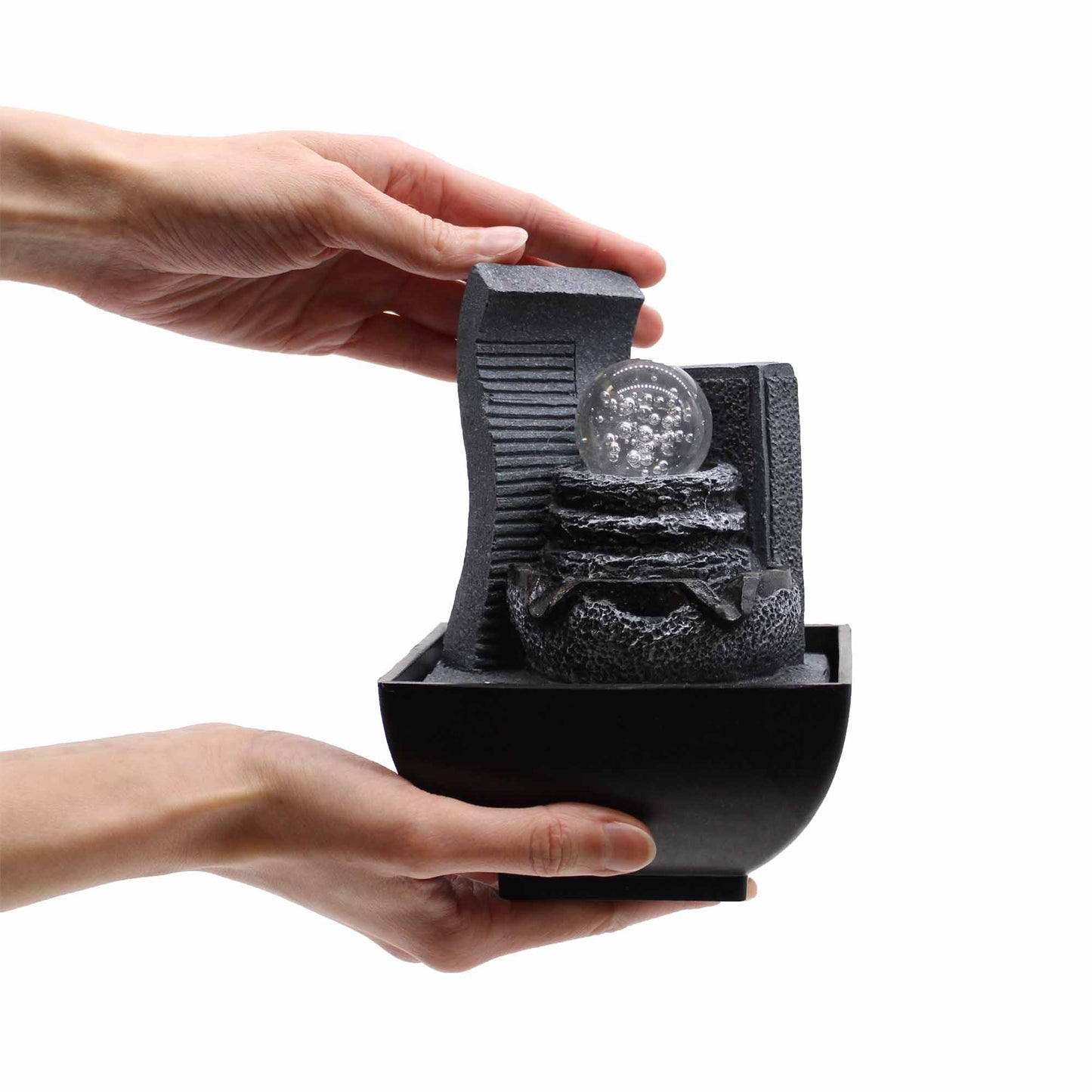 Tabletop Water Feature - 18cm - Relaxing Pouring Pots with textured interior held by a hand on a white background