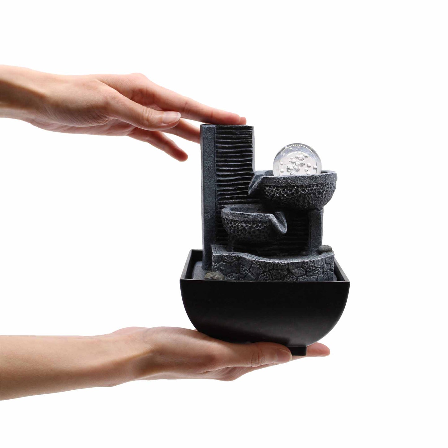 Tabletop Water Feature - 18cm - Relaxing Pouring Pots with a hand interacting with it on a white background