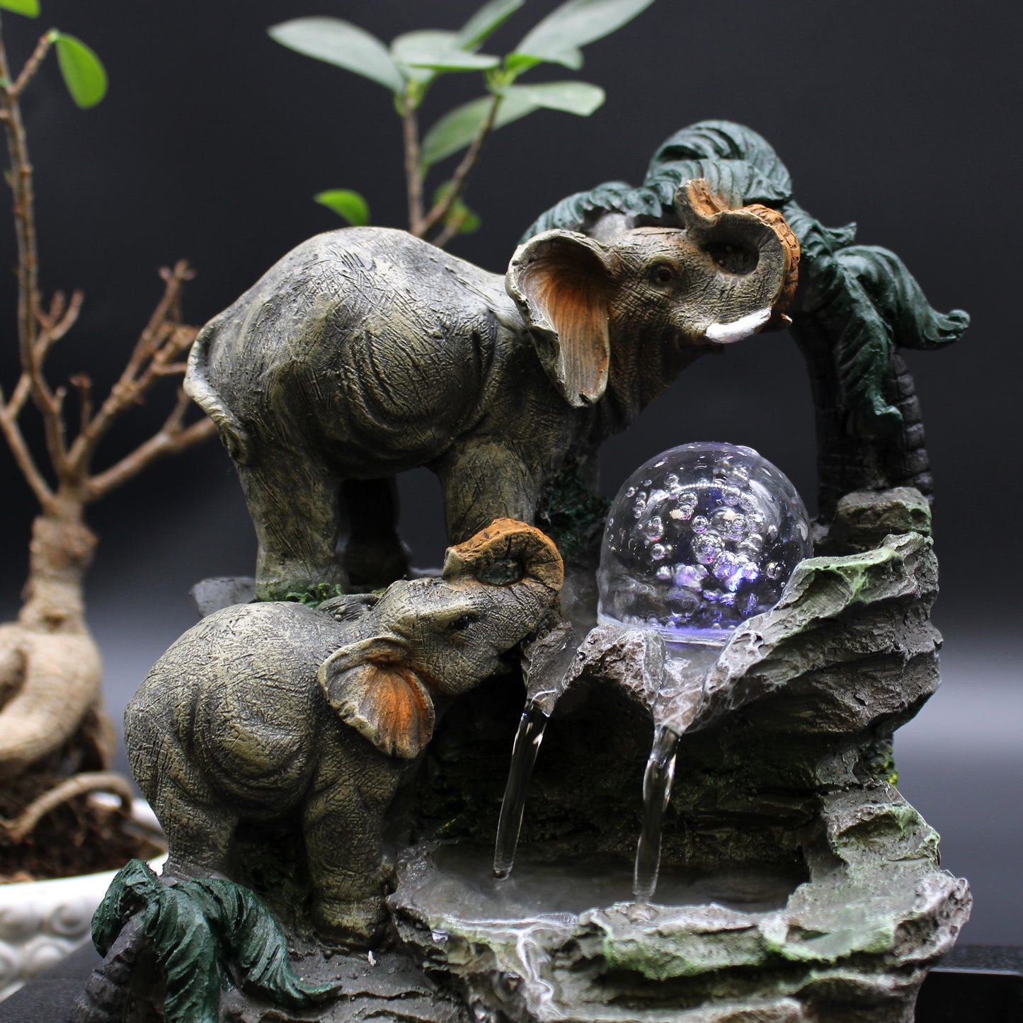 Close-up Tabletop Water Feature - 30cm - Elephant Family with a crystal ball on a rocky base.