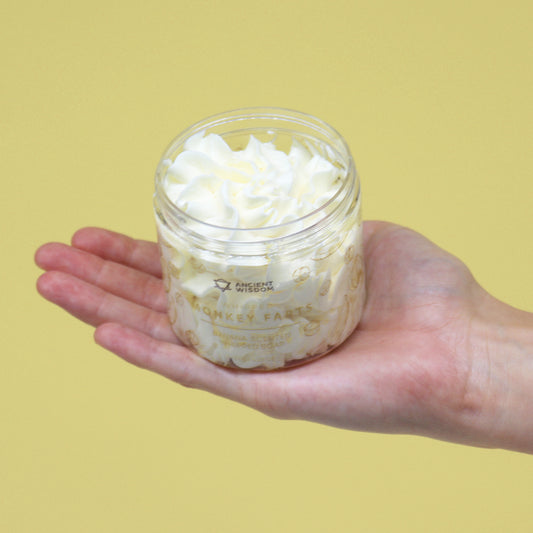 A jar of Banana Whipped Cream Soap in someone hand
