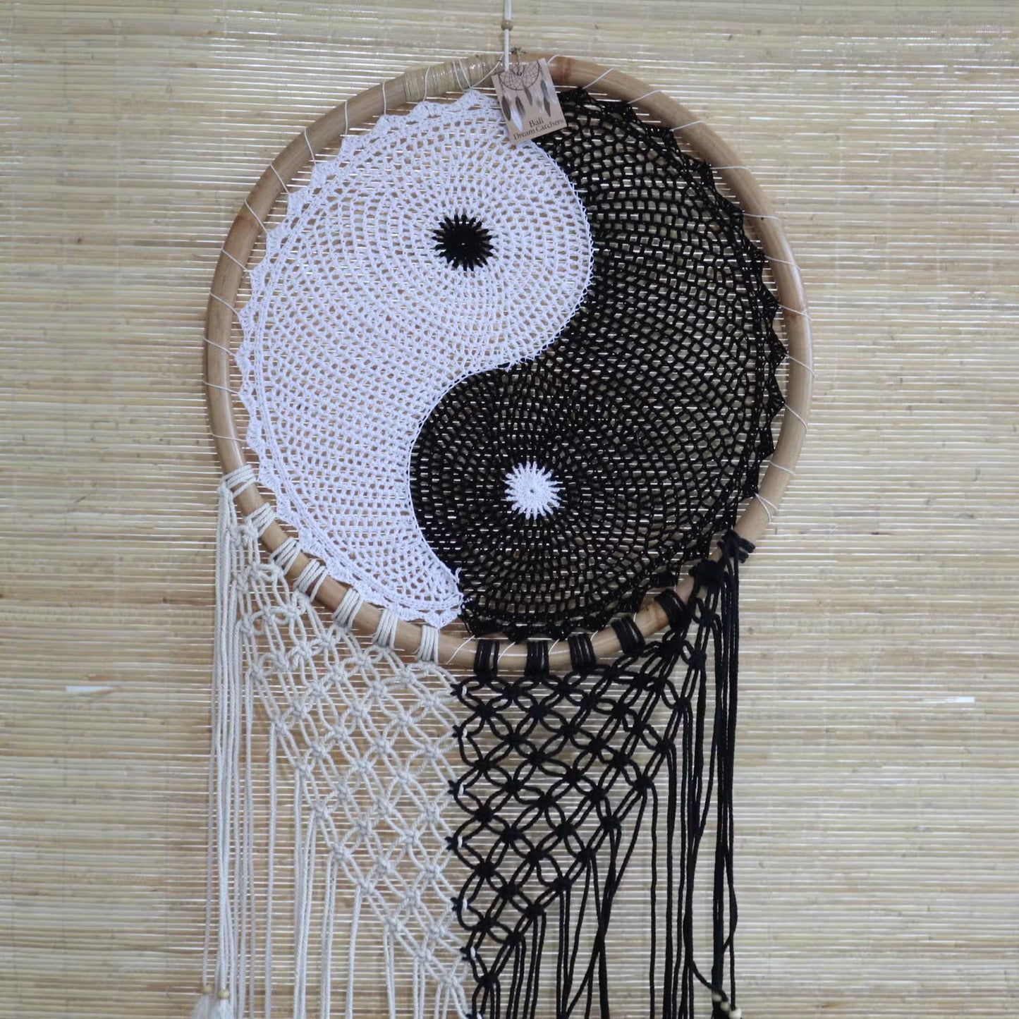 Dreamcatcher with yin yang design on a woven background