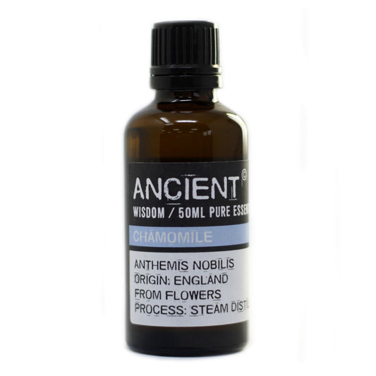 Bottle of chamomile essential oil with a black cap on a white background