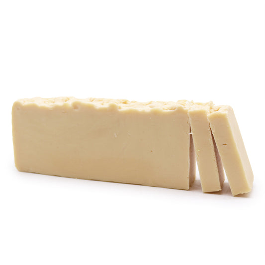 Block of Donkey Milk Olive oil soapwith a few slices cut off on a white background