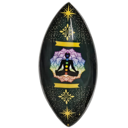 Decorative incense holder with a meditating figure and colorful design in yellow on a black background