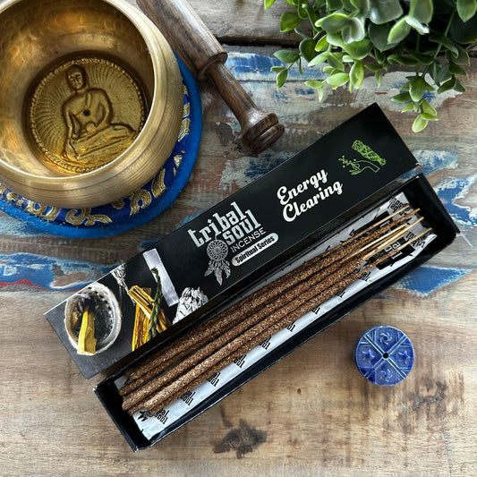 Box of Tribal Soul Energy Clearing Incense with a brass bowl and wooden mace on a wooden surface.