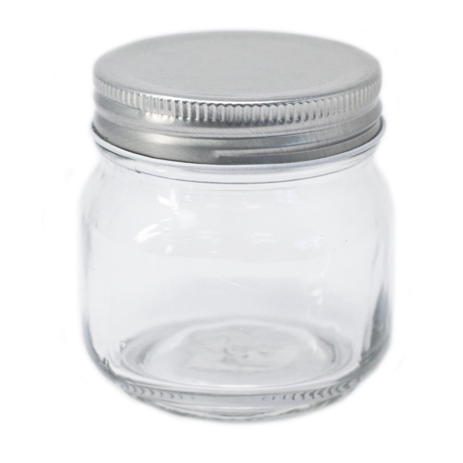 Clear glass jar with a metal lid on a white background