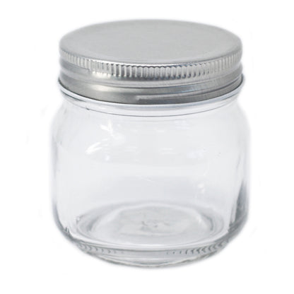 Clear glass jar with a metal lid on a white background