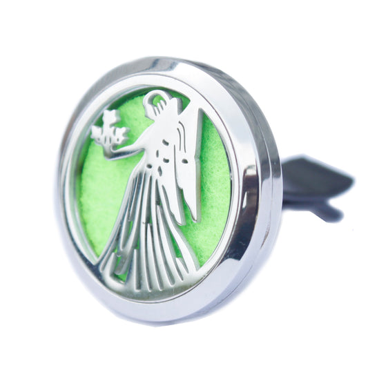 A stainless steel car diffuser kit with a green felt pad and a tree of life design, including space for essential oil.
