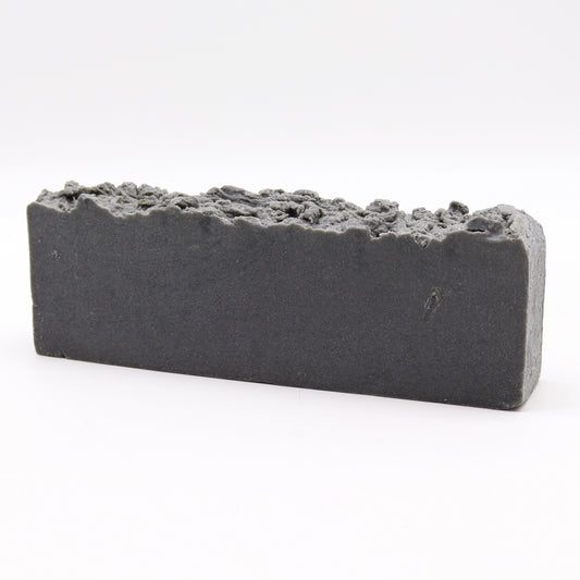A bar of exfoliating soap with a gray color and a rough texture, likely due to the inclusion of pumice.Underground Allure, Essex UK