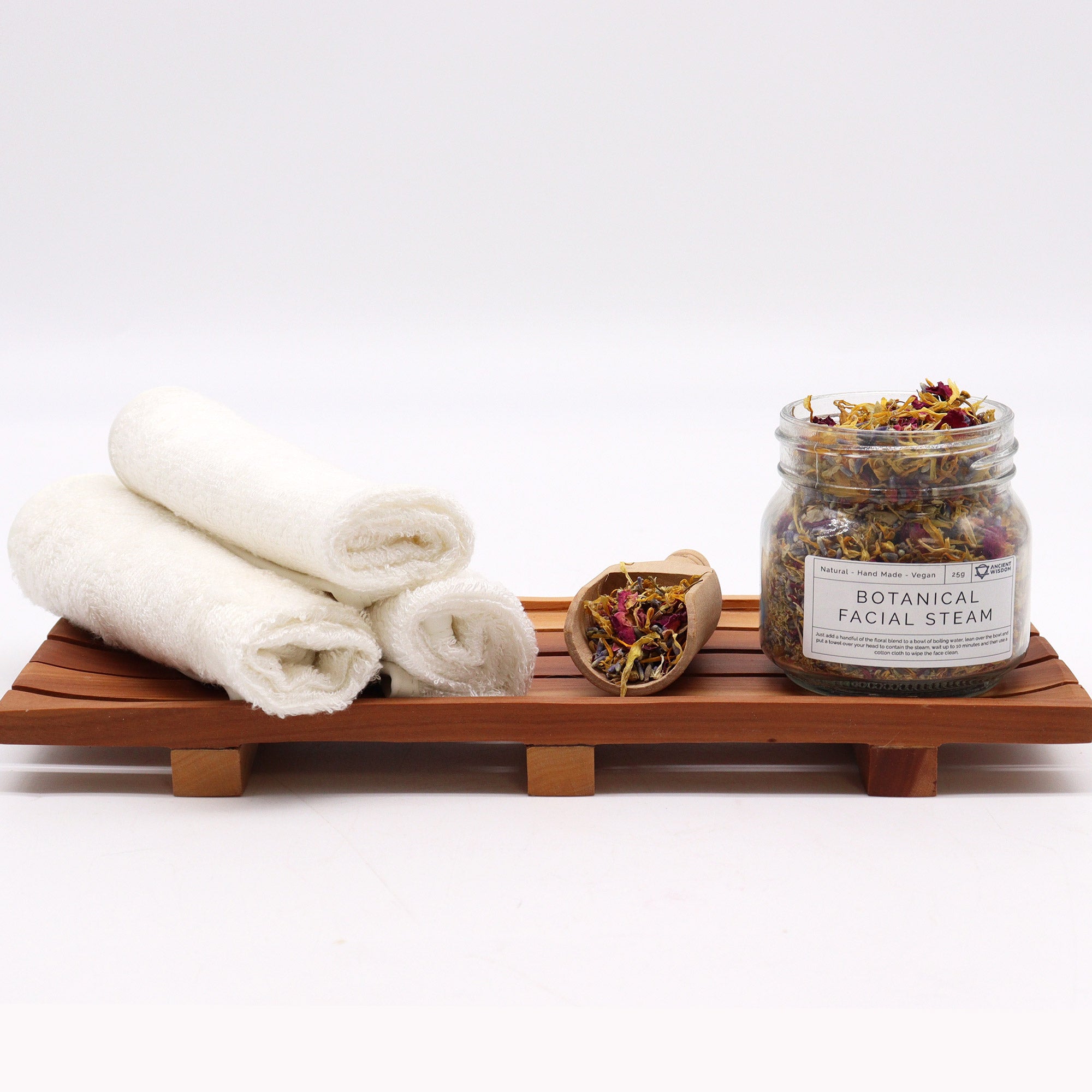 Botanical Facial steam Blend set with white towel on a wooden plater