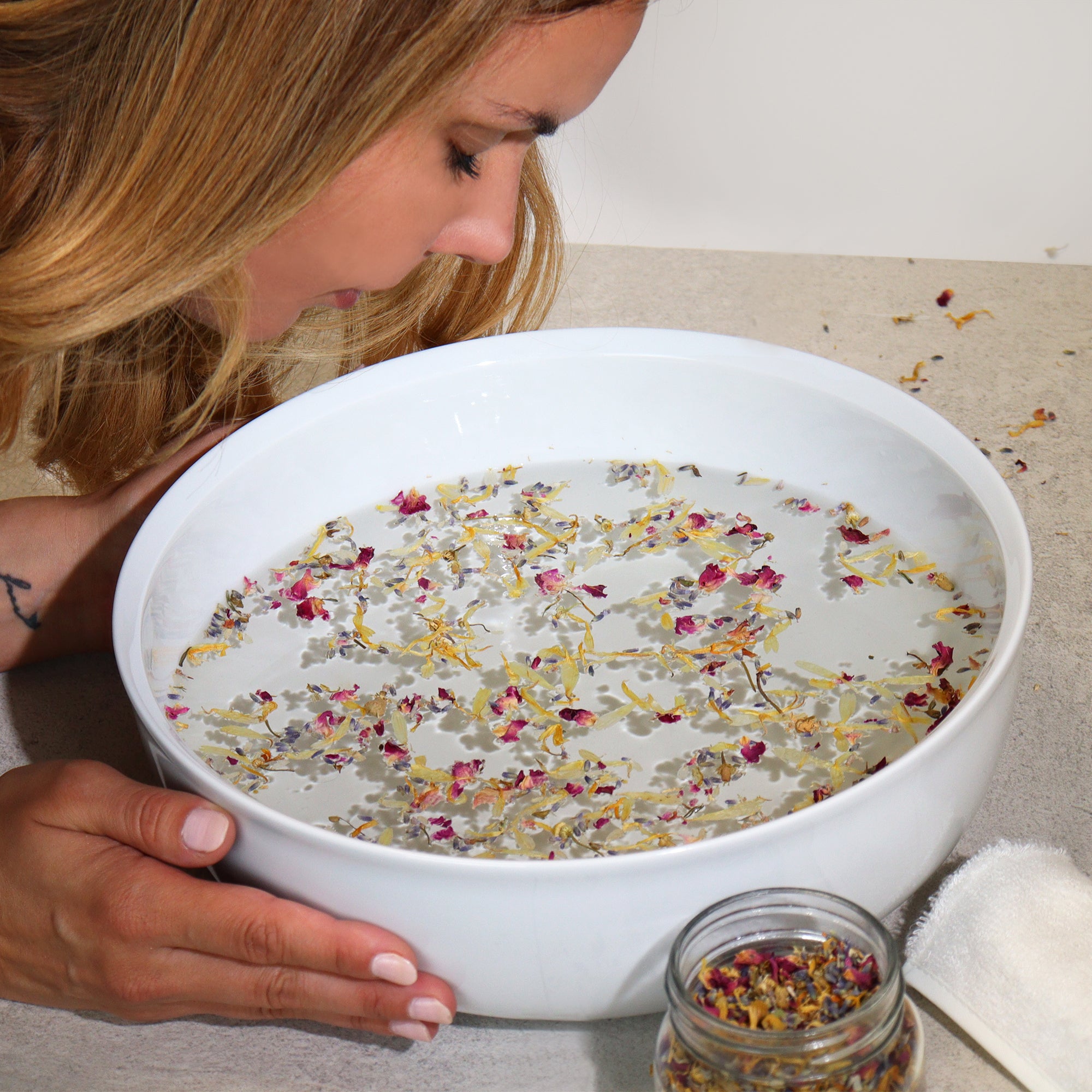 women using facial steam in a bowl