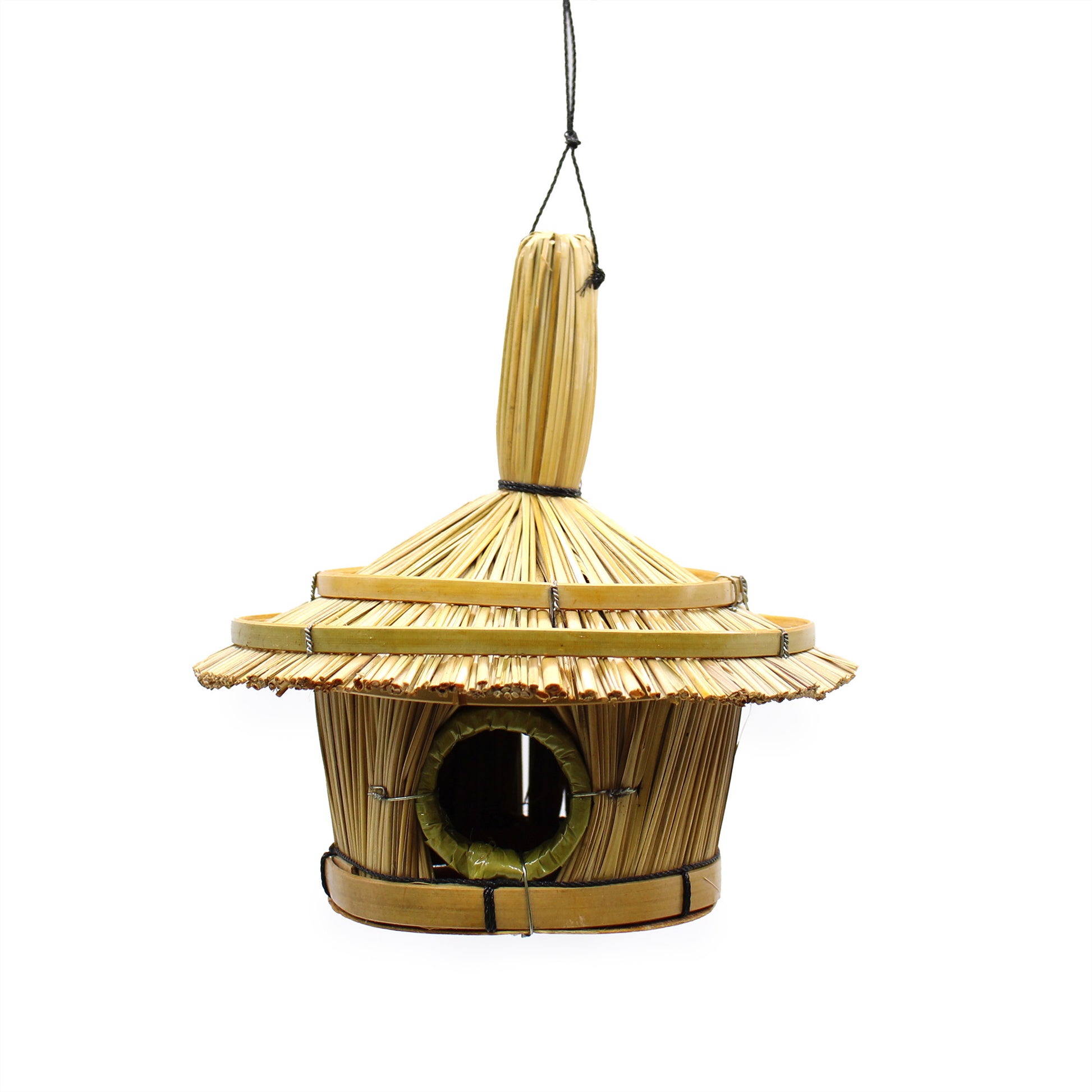 Wooden birdhouse with a thatched roof on a white background