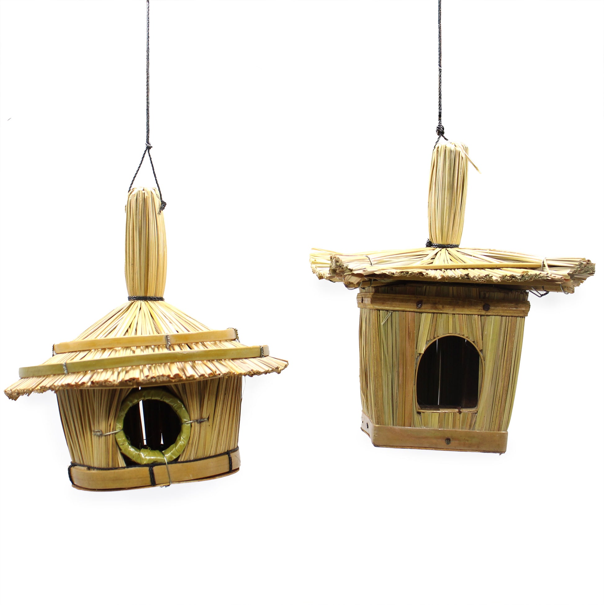 Two bamboo birdhouses hanging against a white background