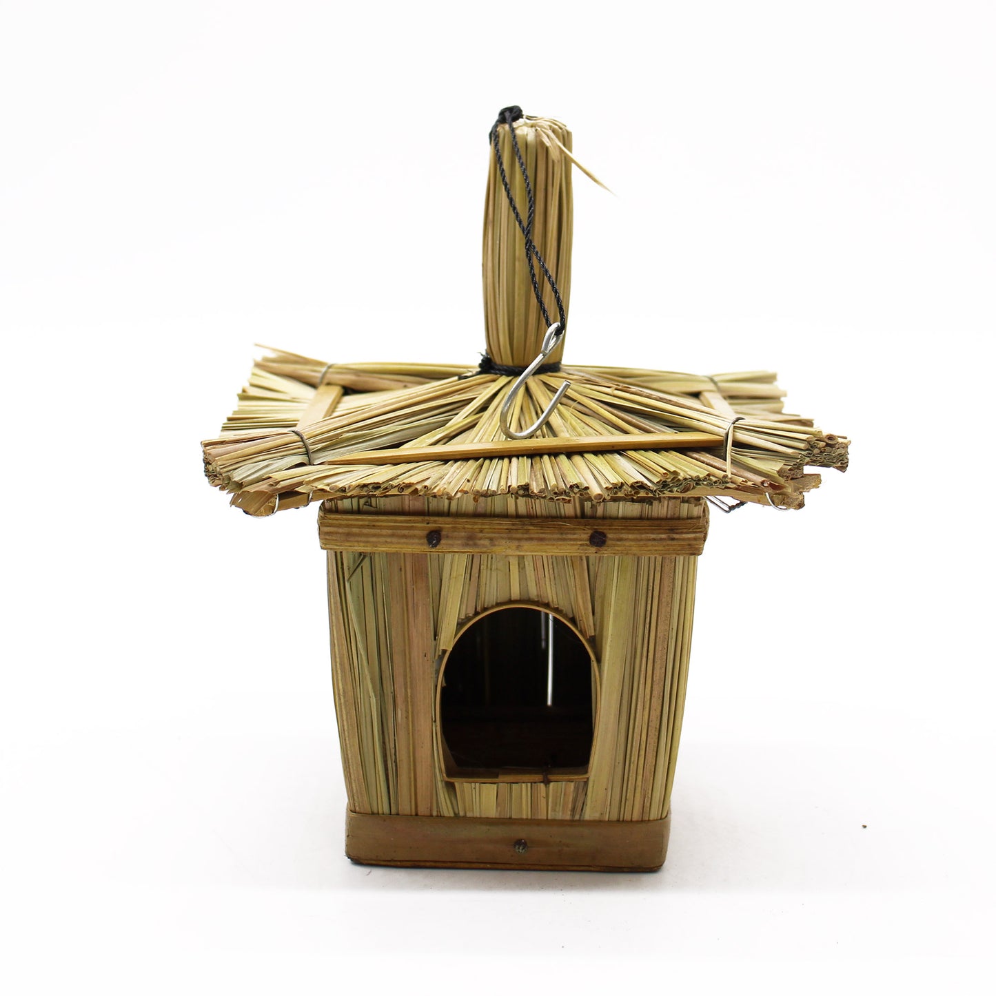 Bamboo birdhouse with thatched roof on a white background