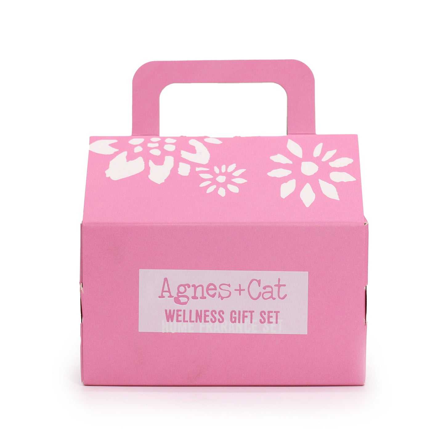 Pink gift box with white floral designs and 'Agnes + Cat Wellness Gift Set' label on a white background