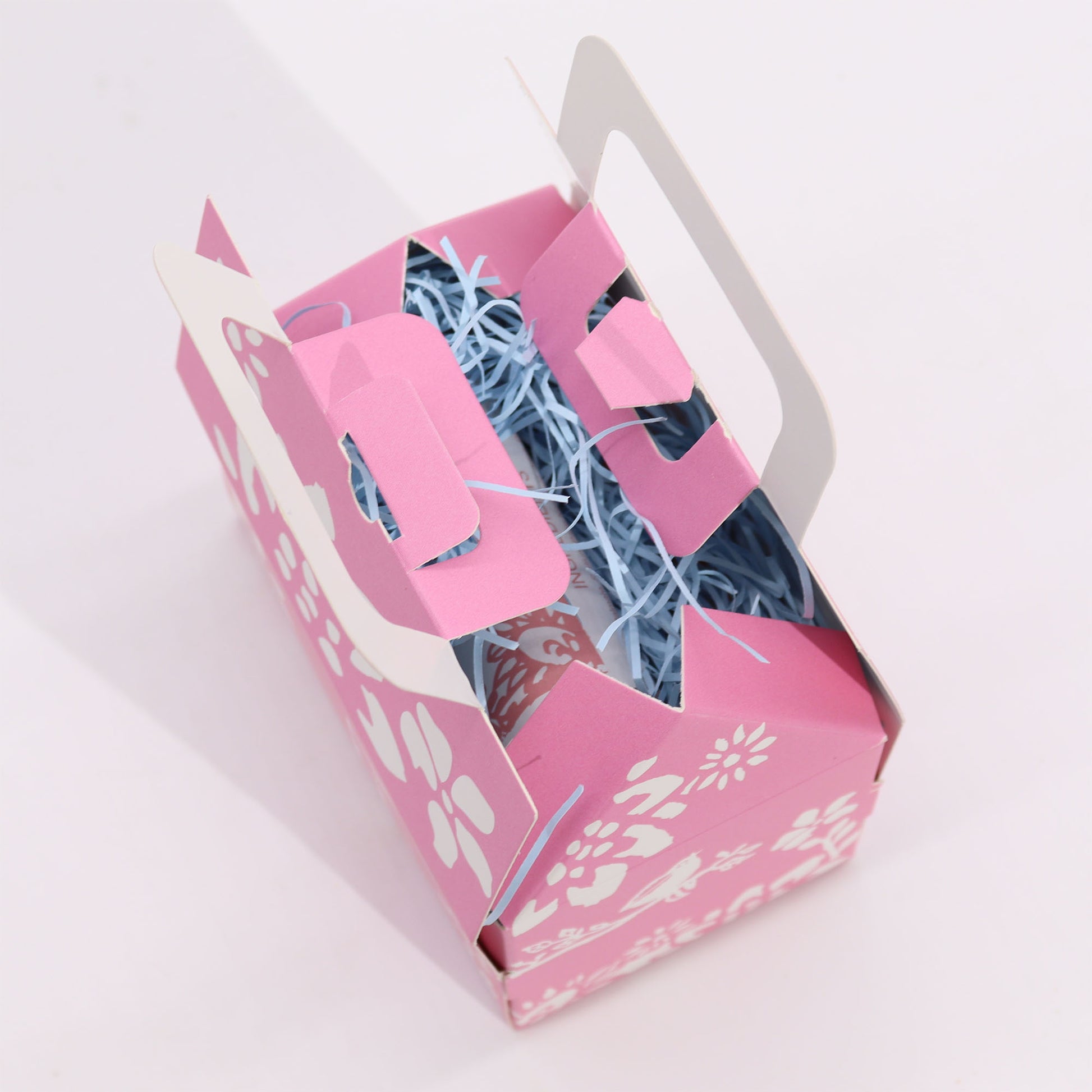 Pink gift box with blue ribbons on a white background