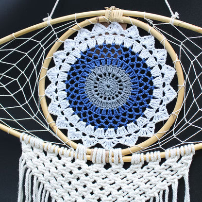 Dreamcatcher with a blue and white Evil Eye Protection on a black background