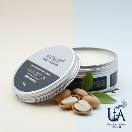 Shea butter containers with nuts and leaves on a light background, featuring the brand 'Underground Allure'.