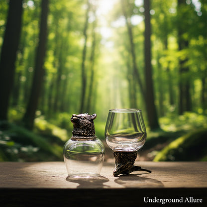 Two 100ml glass containers with animal-shaped tops on a wooden surface in front of a forest background, featuring the brand 'Underground Allure'.