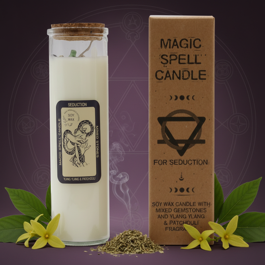 magic spell candle on a dark pink background surrounded by ylang ylang and patchouli