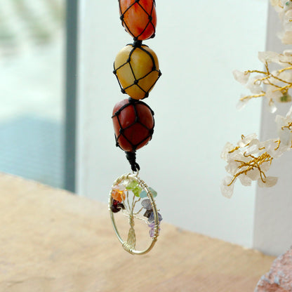 Close up view Hanging Chakra Stone Pendant - Tree of Life with blurred background