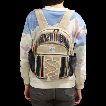 Person wearing a colorful backpack with a patterned design on a black background