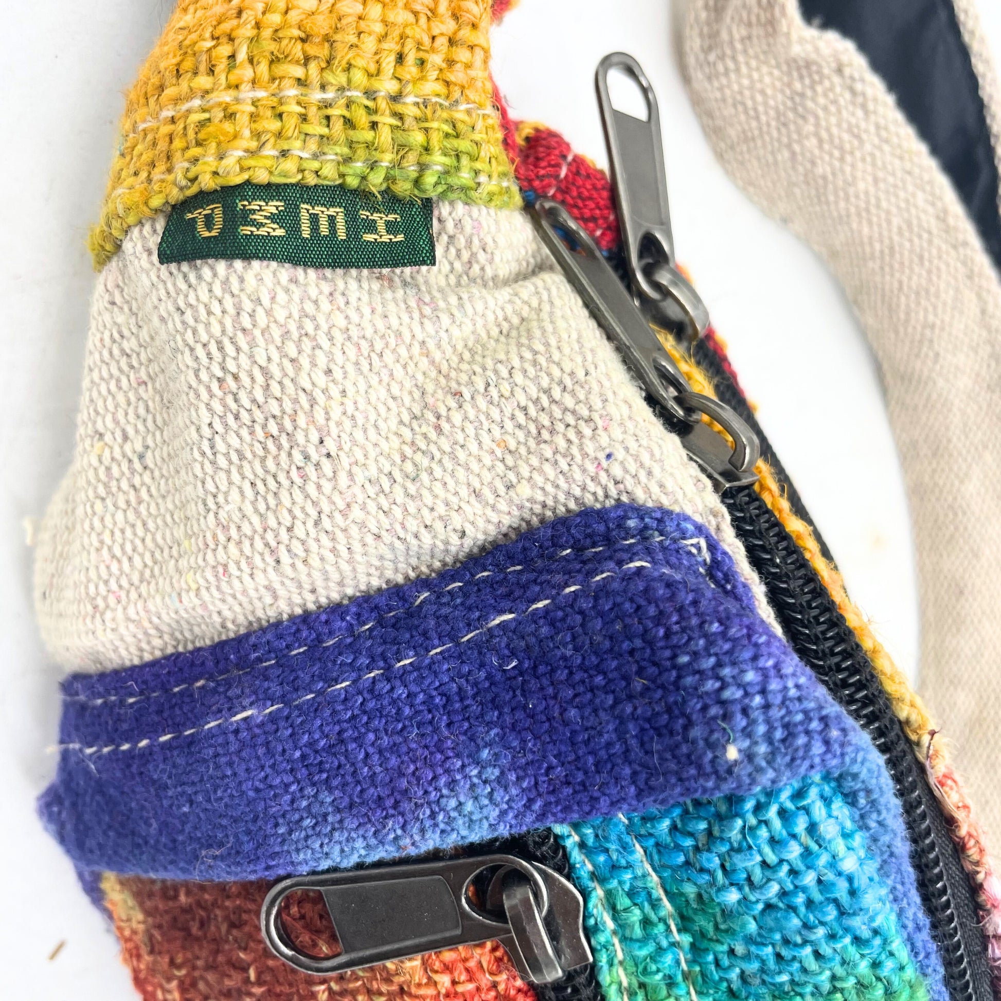 Colorful fabric pouch with a zipper and 'UMI' label on a white background