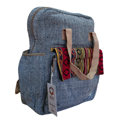 Blue textured backpack with colorful patterned straps on a white background