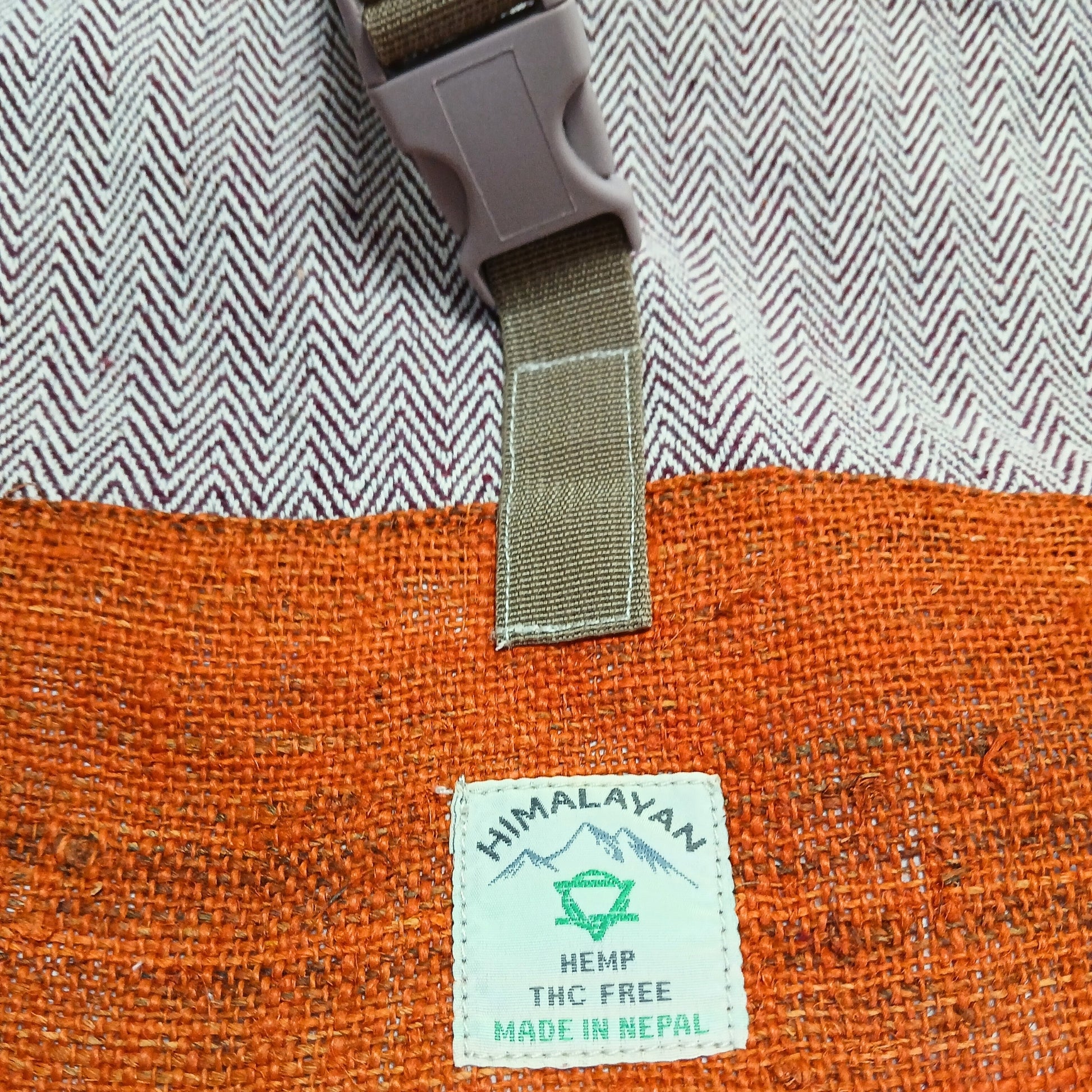 Orange fabric with a Himalayan Hemp tag on a textured background