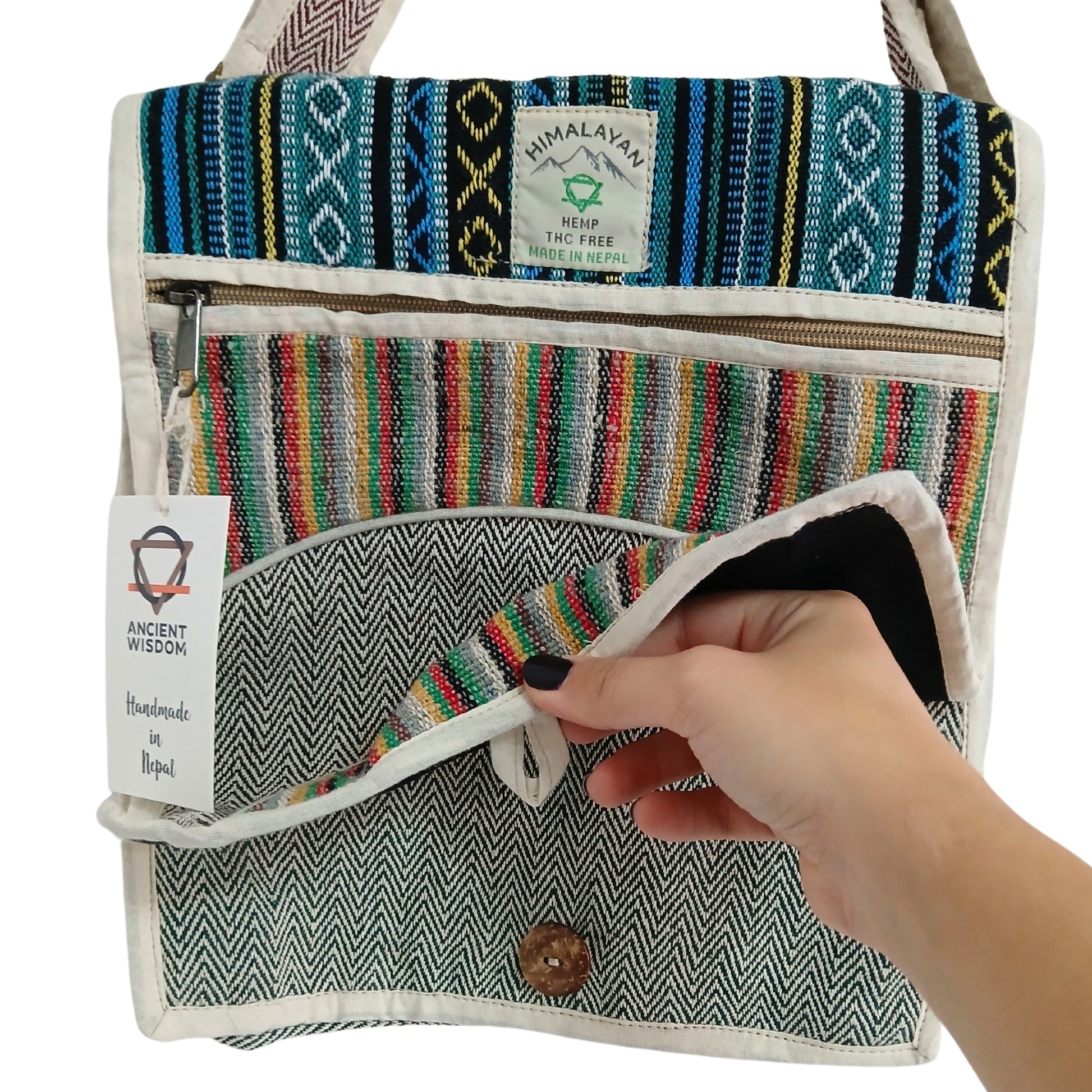 Handmade bag with colorful patterns and a visible brand label, held by a hand.