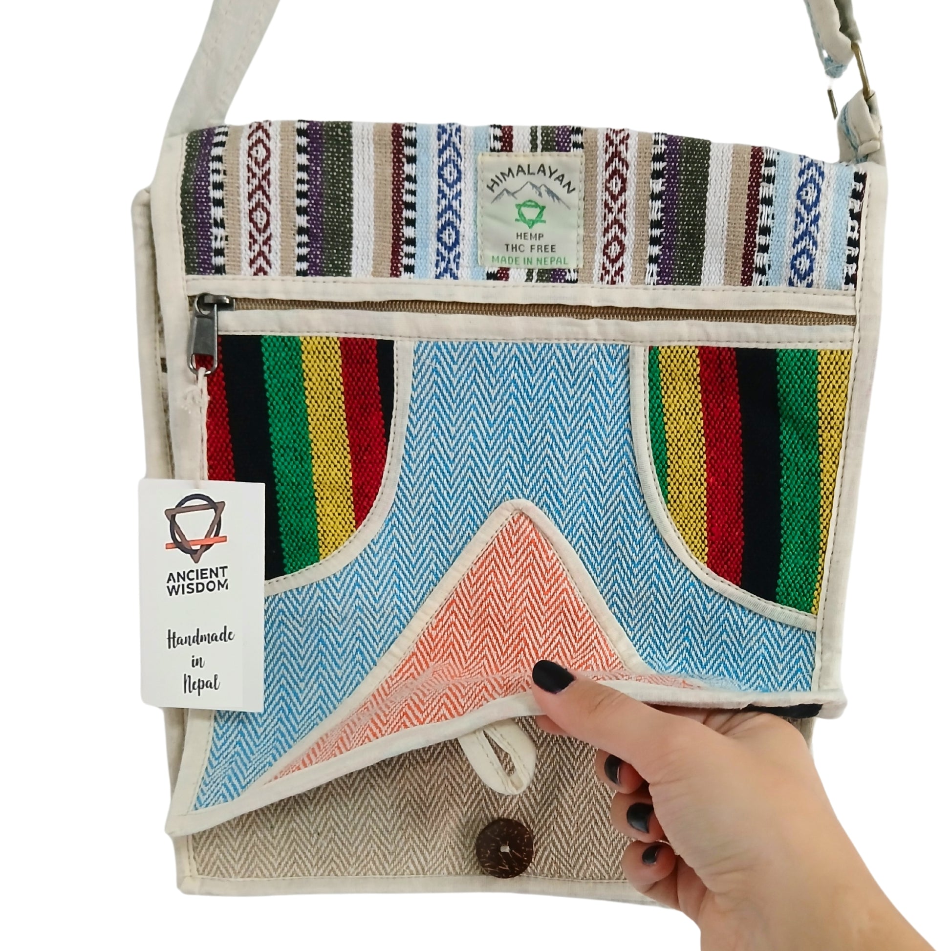 Handbag with colorful striped pattern held by a hand, brand 'Ancient Wisdom' visible