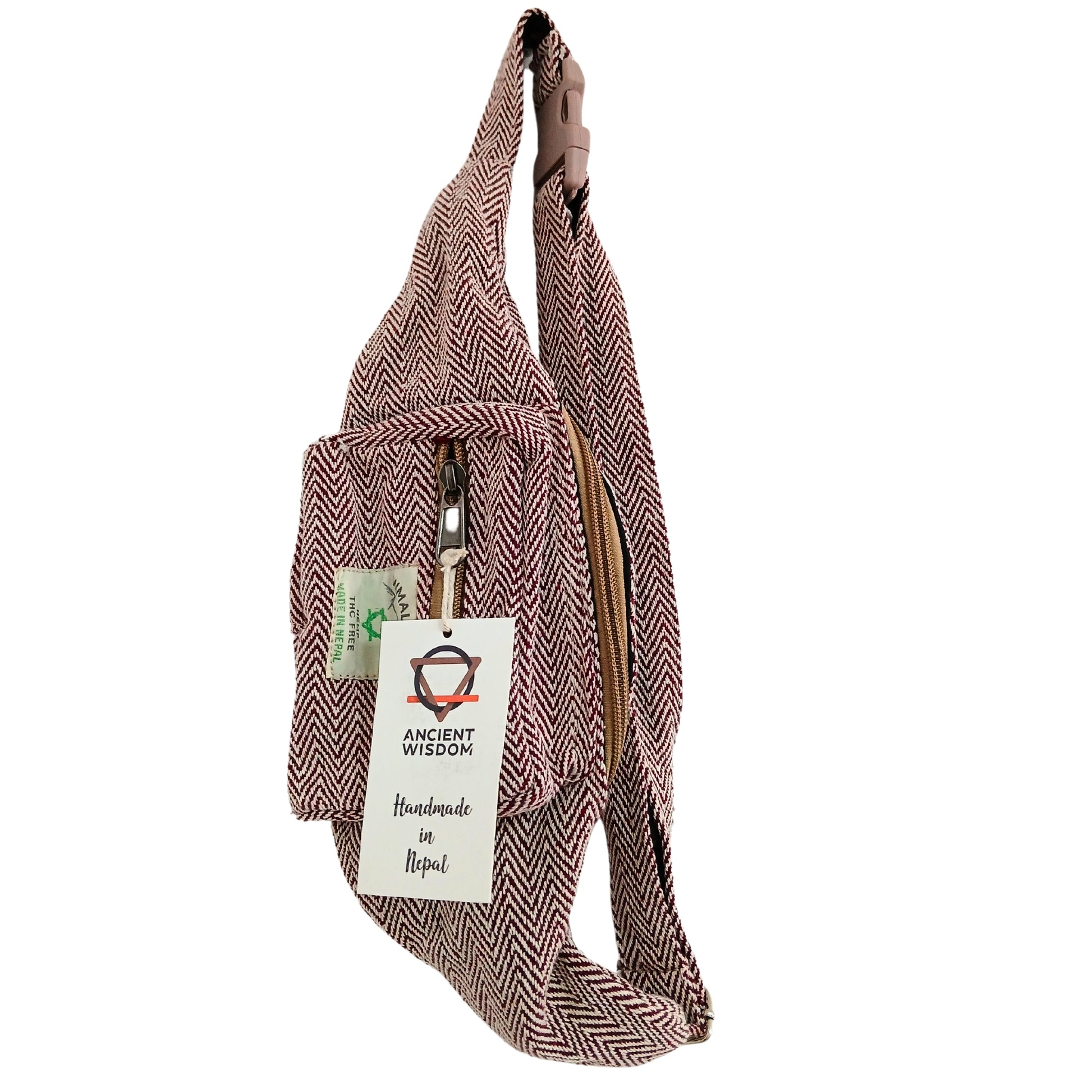 Brown herringbone patterned sling bag with a visible brand tag on a white background