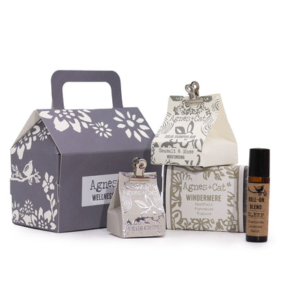 Collection of Agnes + Cat wellness products including a box, bottle, and other packaging on a white background.