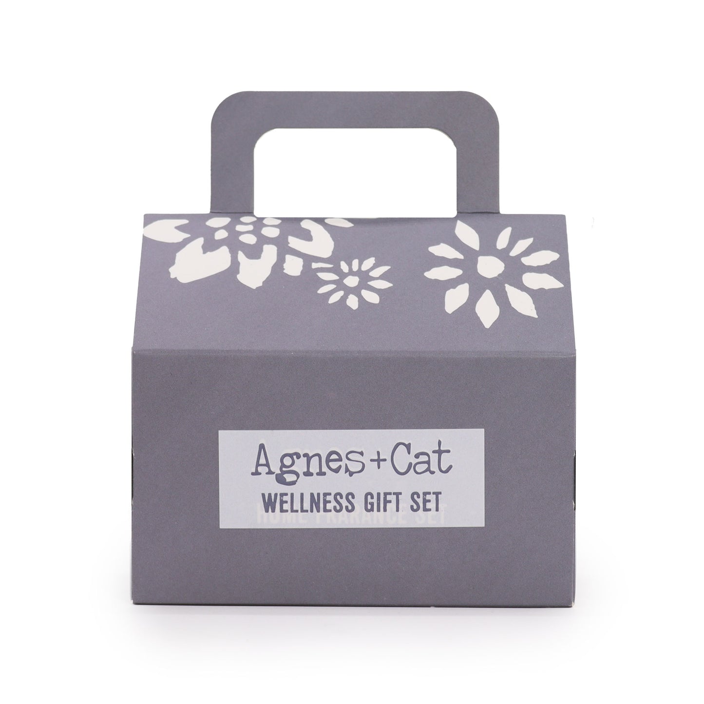 Gray gift box with floral designs and 'Agnes + Cat Wellness Gift Set' label on a white background