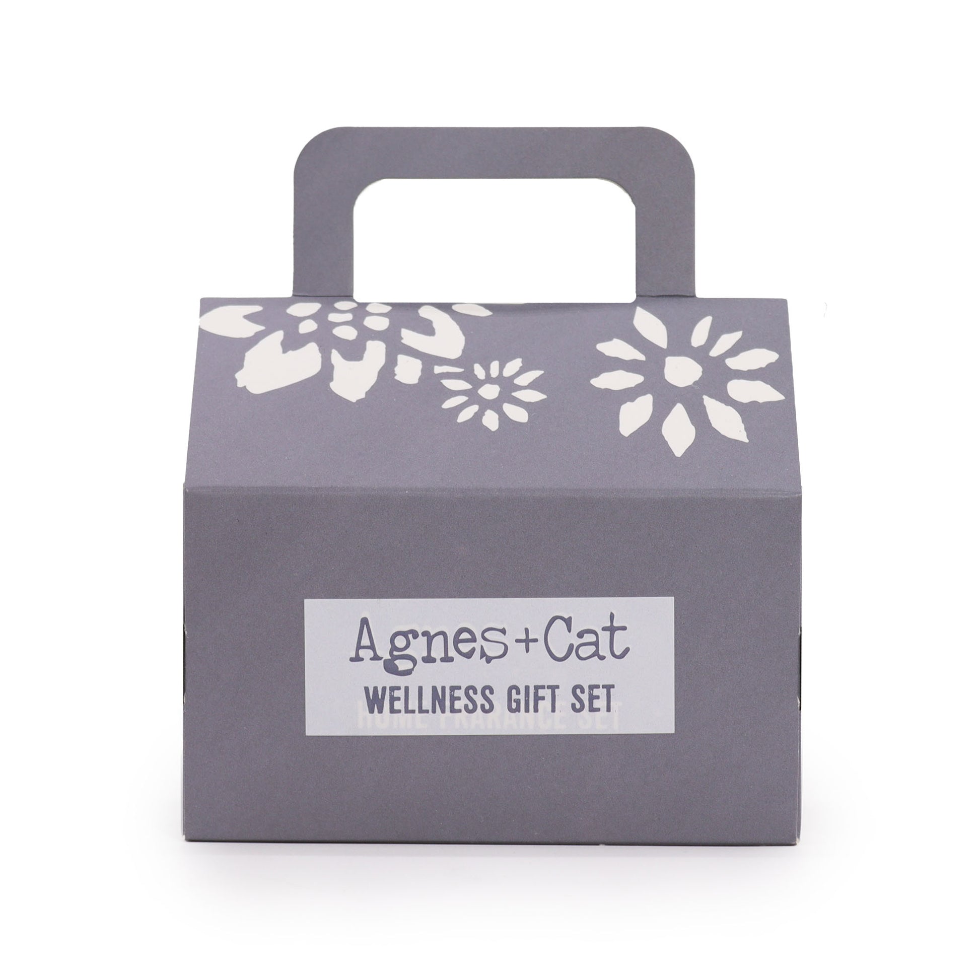 Gray gift box with floral designs and 'Agnes + Cat Wellness Gift Set' label on a white background
