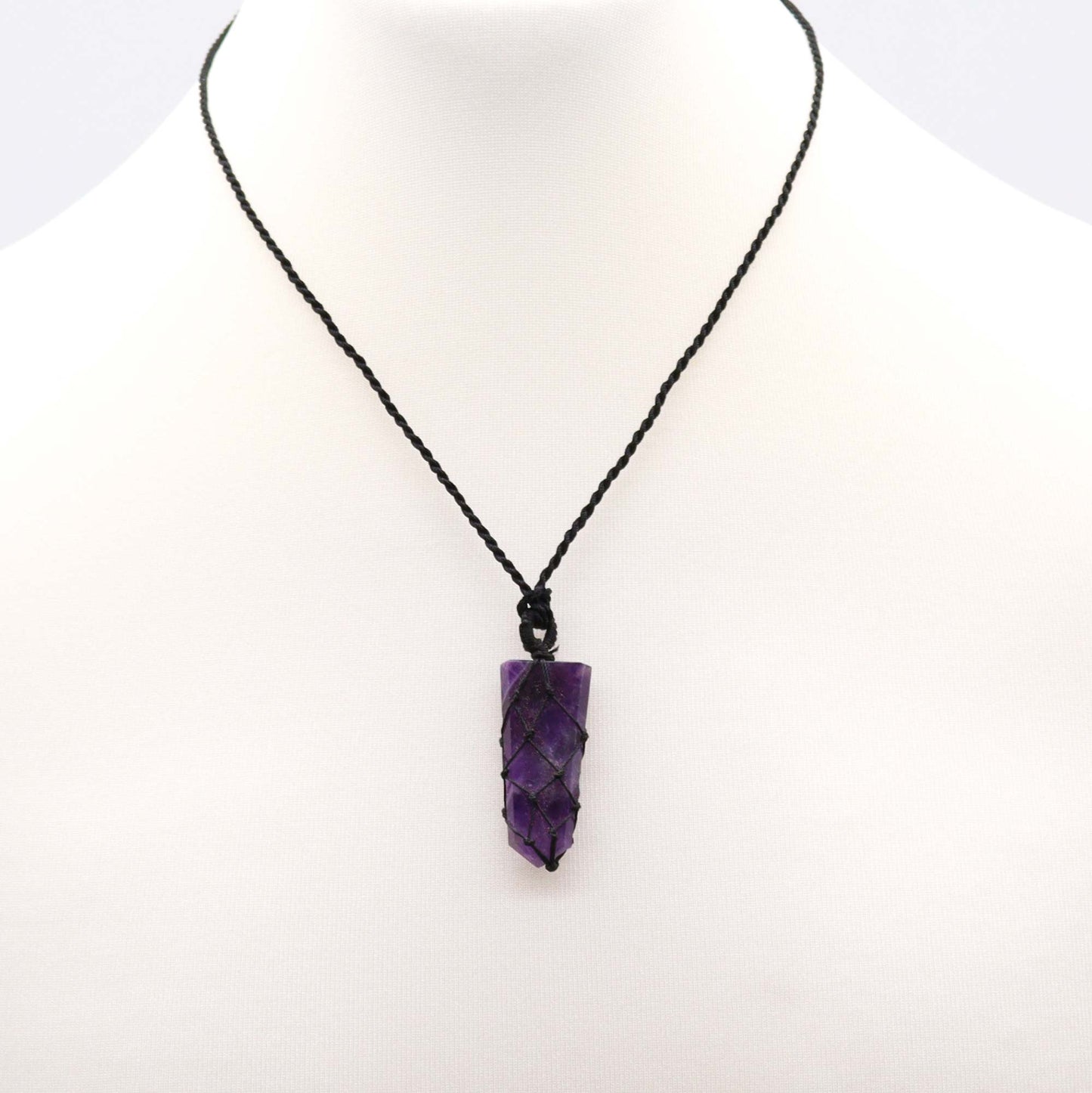 Amethyst pencil pendant necklace on a white background
