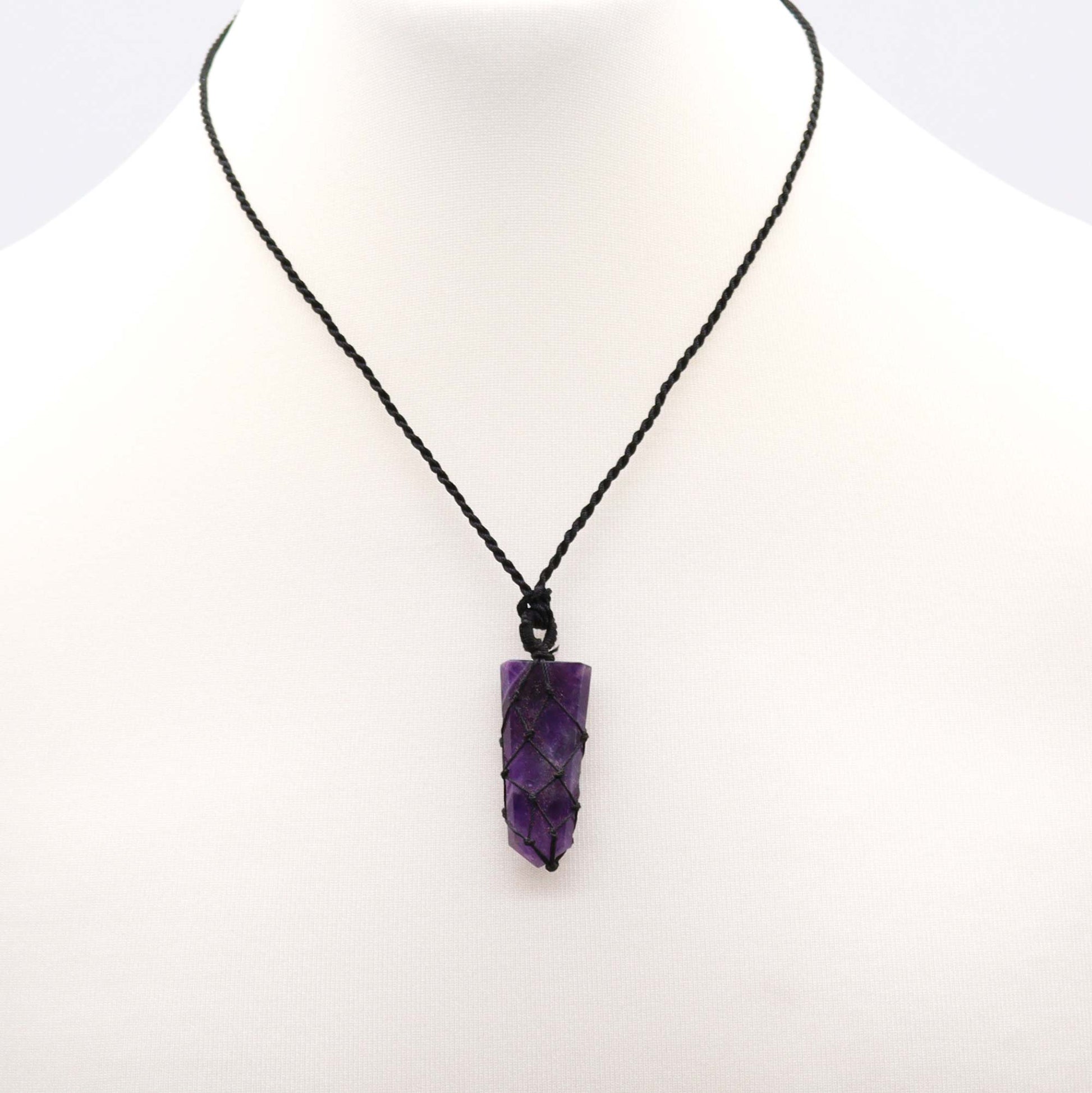Amethyst pencil pendant necklace on a white background