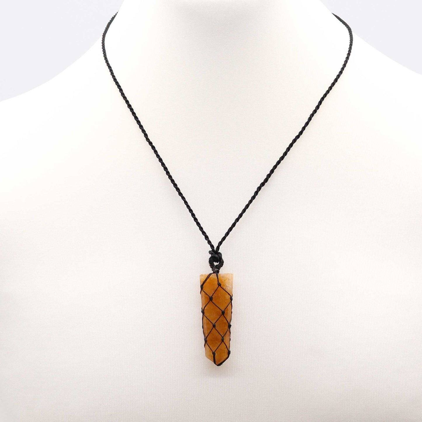 Necklace with a golden pencil pendant on a white background