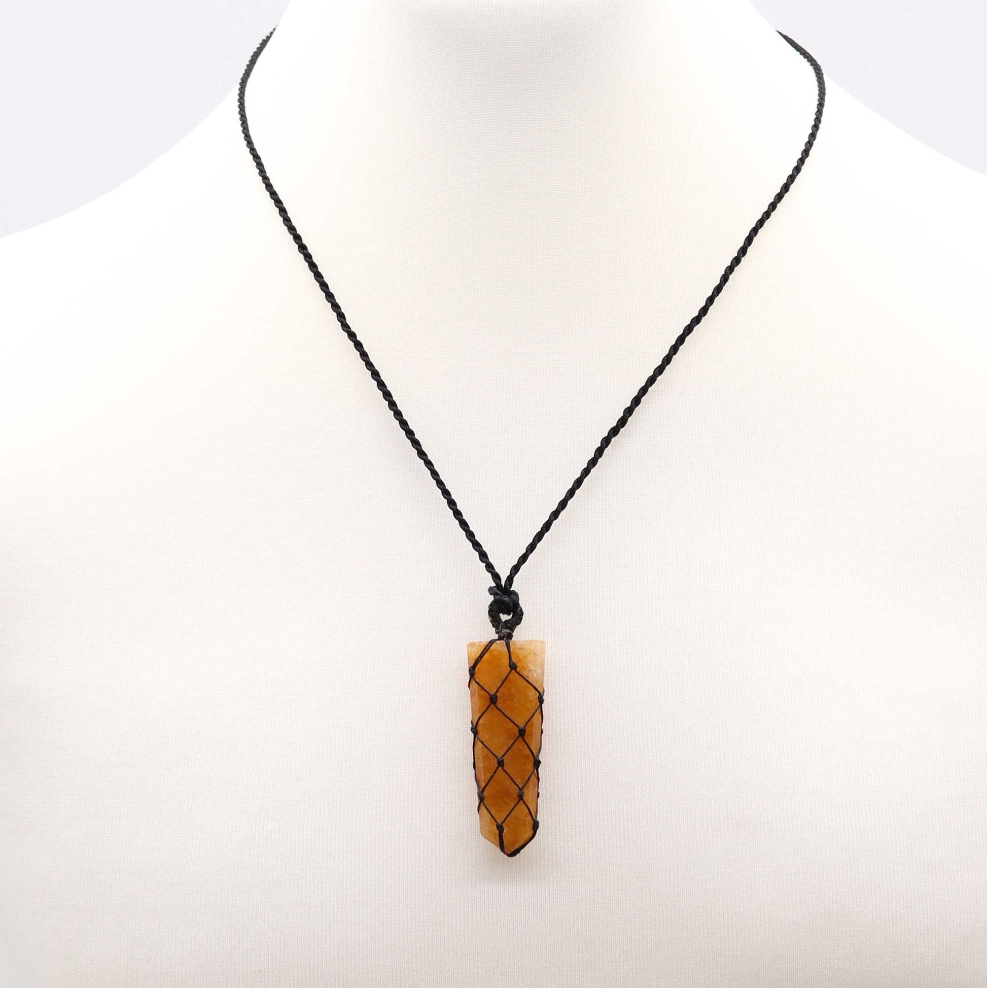 Necklace with a golden pencil pendant on a white background
