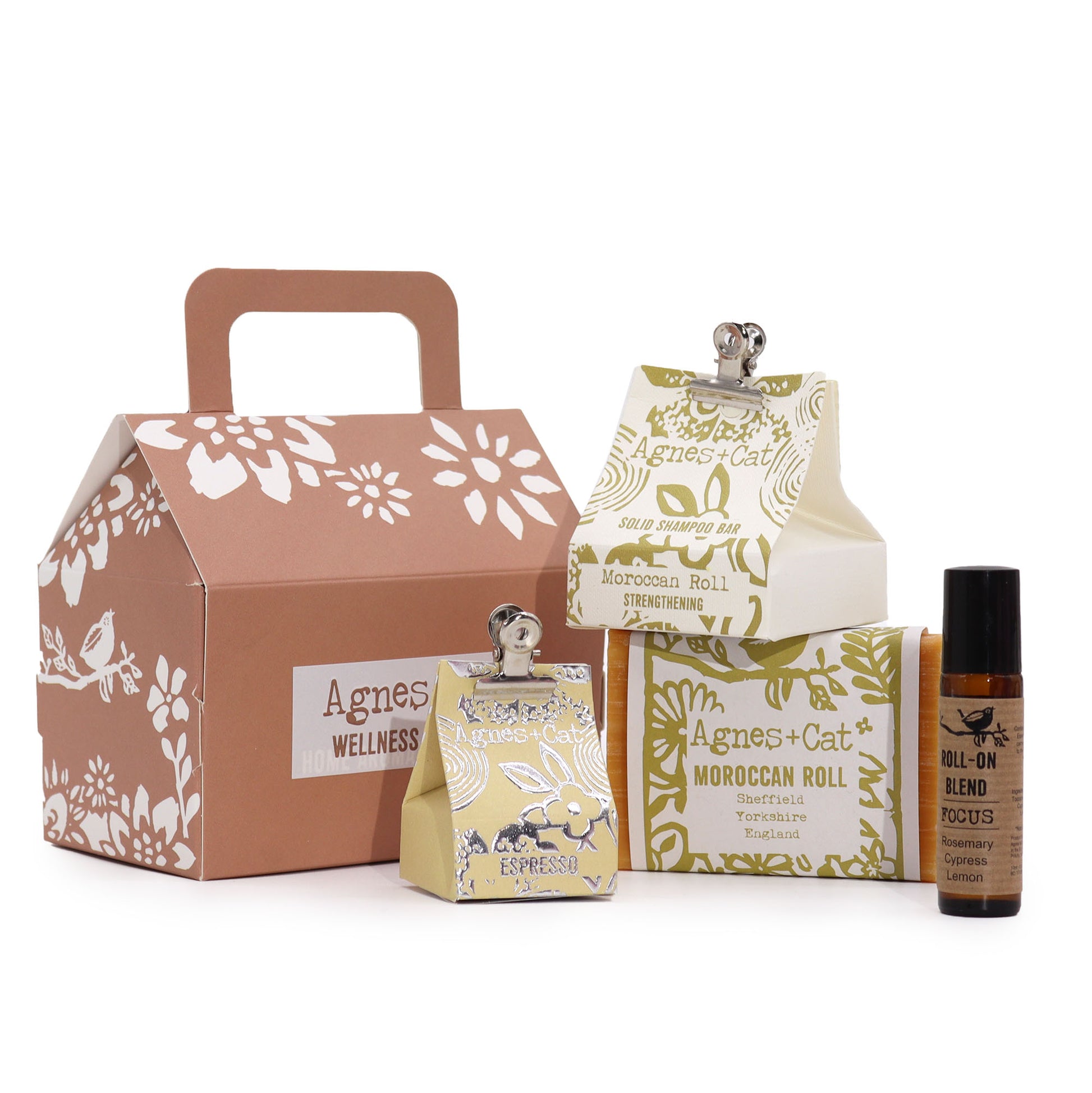 Collection of Agnes + Cat wellness products including a box, diffuser, and rollerball on a white background.