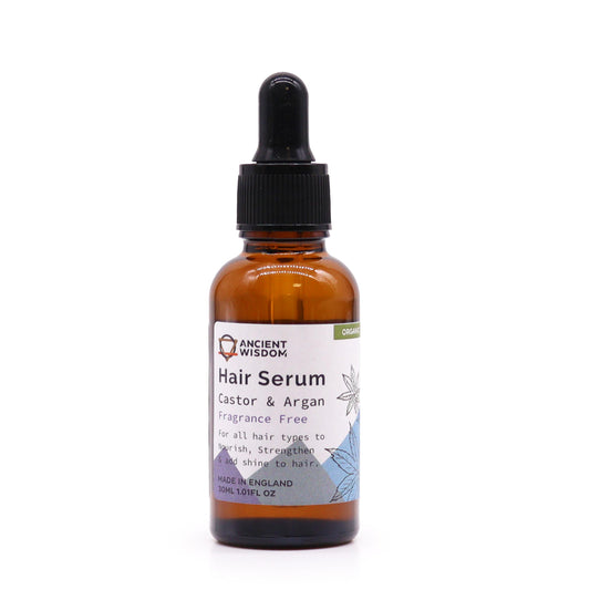 A bottle of Ancient Wisdom Organic Hair Serum with a label indicating 'Castor & Argan Oils' and 'All Natural ingredients'. The bottle is amber-colored and has a dropper.