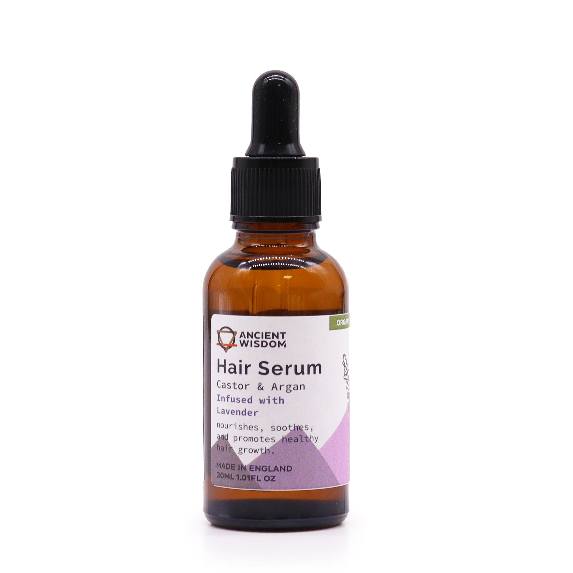 A bottle of Ancient Wisdom Organic Hair Serum with a label indicating 'Castor & Argan Oils' and 'Lavender'. The bottle is amber-colored and has a dropper.